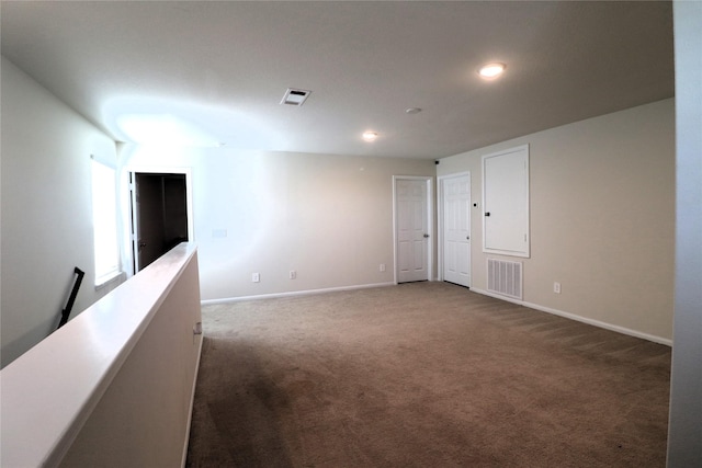 carpeted spare room featuring recessed lighting, visible vents, and baseboards