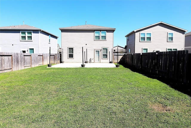 rear view of property with a patio area, a fenced backyard, and a yard