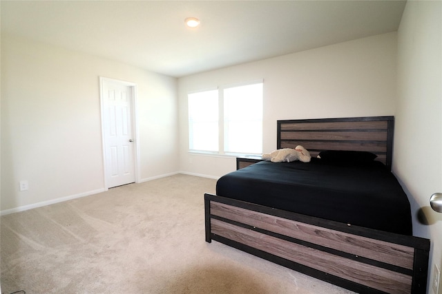 bedroom with baseboards and carpet floors