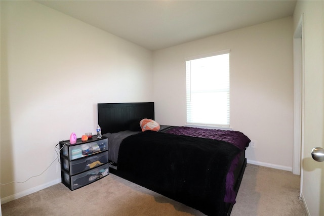 bedroom featuring carpet flooring and baseboards