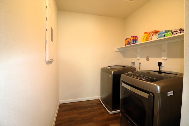 laundry room featuring dark wood-style floors, baseboards, washing machine and dryer, and laundry area