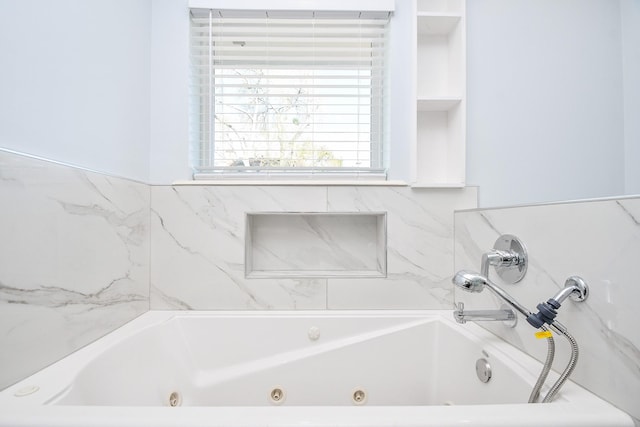 bathroom featuring a tub with jets