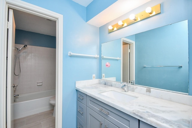 bathroom featuring bathing tub / shower combination, toilet, and vanity