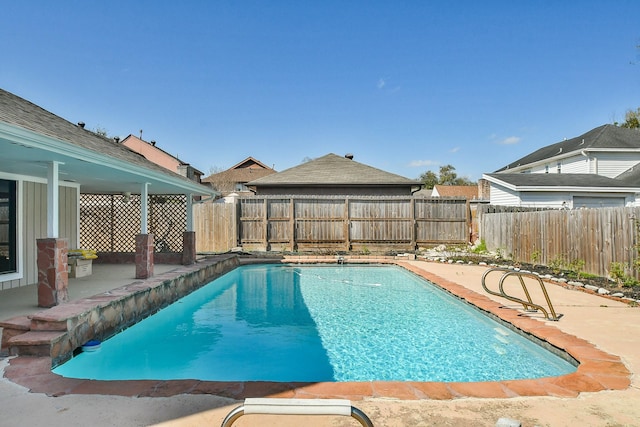 view of swimming pool featuring a fenced in pool, a patio, and a fenced backyard