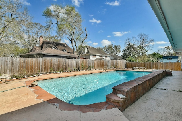 view of swimming pool with a patio, a fenced in pool, and a fenced backyard