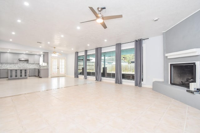 living room featuring recessed lighting, a fireplace with raised hearth, baseboards, and ceiling fan