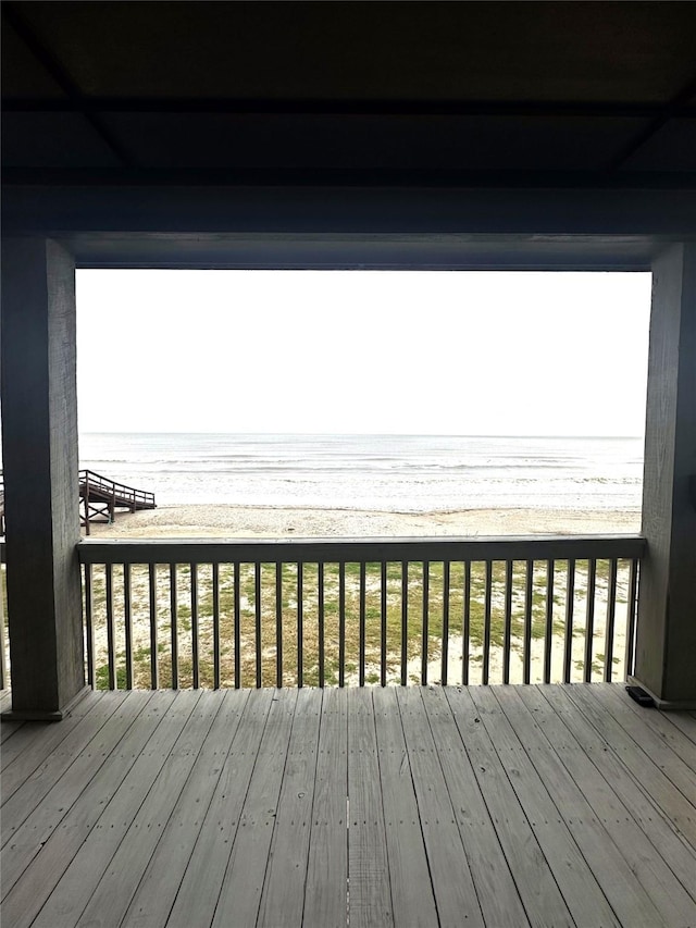 wooden terrace featuring a water view