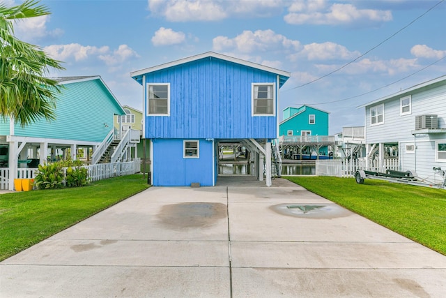 16710 Kingston Way, Jamaica Beach, TX 77554 - view of front of home featuring a carport, stairs, central AC, driveway, and a front lawn