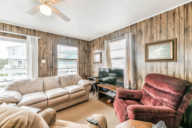 16710 Kingston Way, Jamaica Beach, TX 77554 - carpeted living area featuring wood walls and a ceiling fan