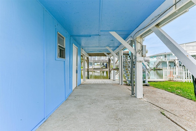 16710 Kingston Way, Jamaica Beach, TX 77554 - view of patio / terrace featuring stairway, a water view, and fence