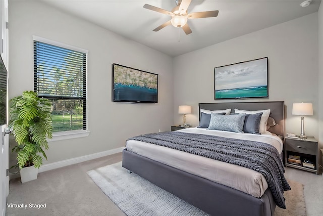 bedroom with ceiling fan, carpet, and baseboards