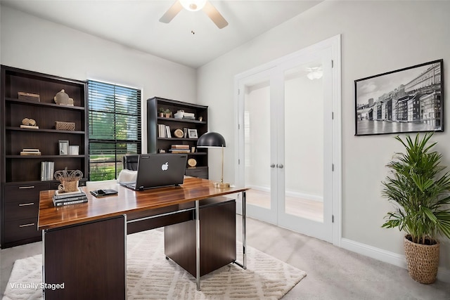 office with french doors, light carpet, baseboards, and a ceiling fan