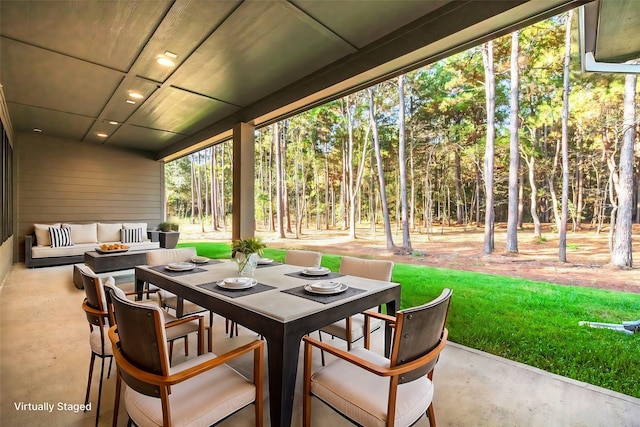 view of patio / terrace with outdoor dining area and an outdoor living space with a fire pit