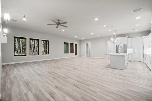 unfurnished living room with recessed lighting and visible vents