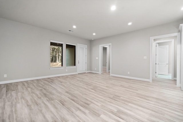 spare room with baseboards, recessed lighting, visible vents, and light wood-type flooring