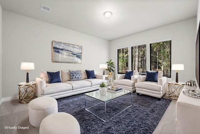 living area featuring visible vents, carpet floors, and baseboards