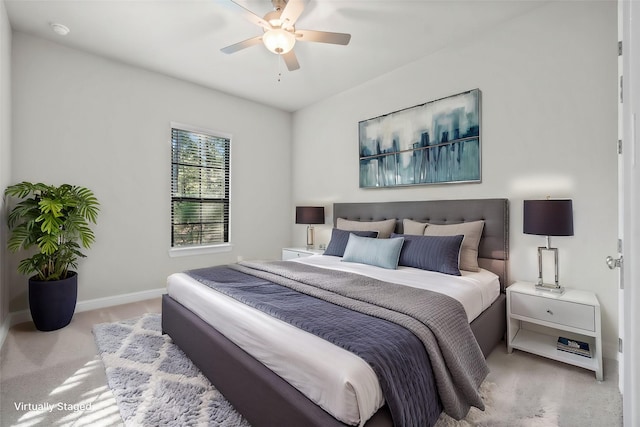 carpeted bedroom featuring baseboards and ceiling fan