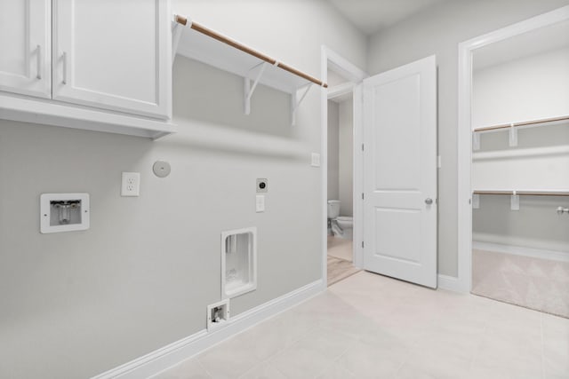 laundry room featuring baseboards, washer hookup, hookup for a gas dryer, cabinet space, and hookup for an electric dryer