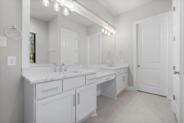 bathroom with double vanity, tile patterned floors, and a sink