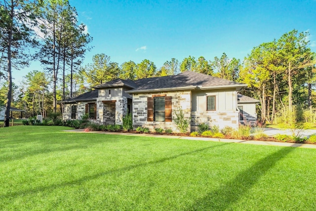 prairie-style house featuring stone siding, board and batten siding, and a front lawn