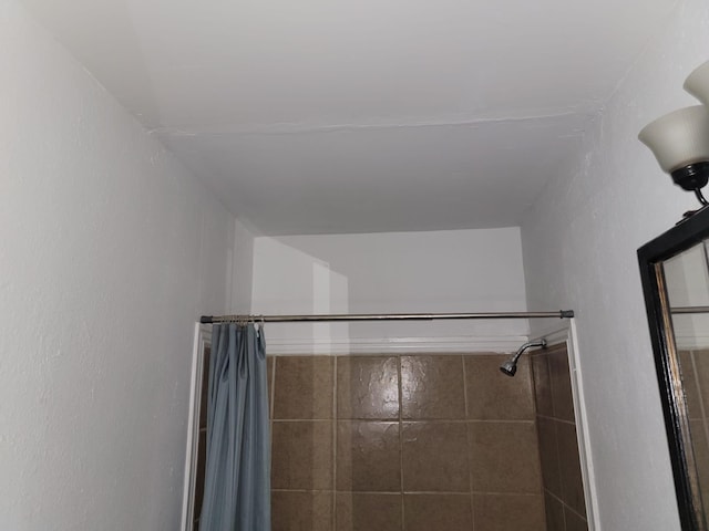 full bathroom with a tile shower