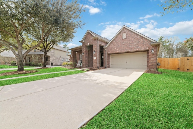 traditional-style home with fence, a front lawn, concrete driveway, a garage, and brick siding