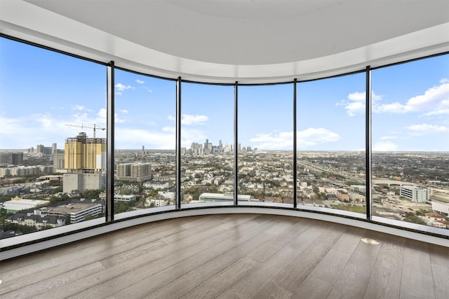 unfurnished sunroom with a city view