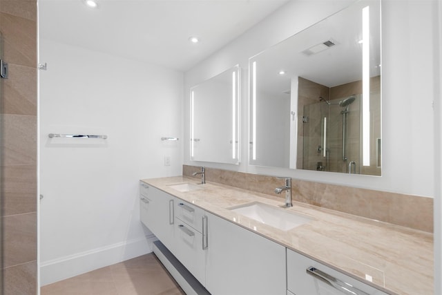 full bathroom with a sink, visible vents, a stall shower, and double vanity