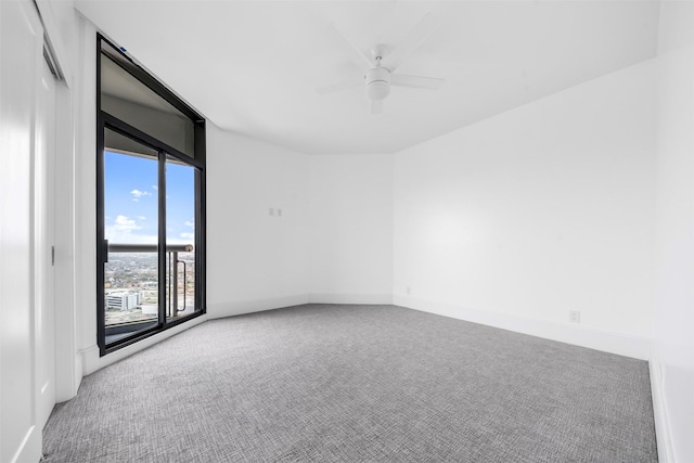 empty room with a ceiling fan, carpet, and baseboards