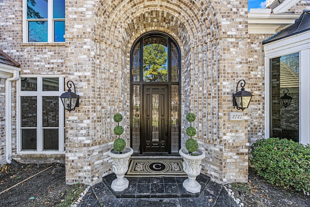 doorway to property with brick siding