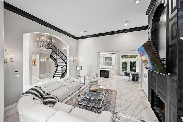 living area featuring an inviting chandelier, stairway, crown molding, and marble finish floor