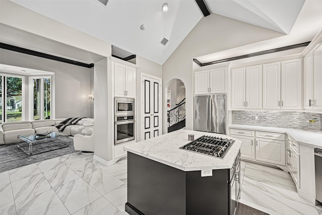 kitchen featuring decorative backsplash, visible vents, marble finish floor, and stainless steel appliances