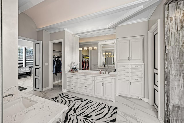 bathroom with vanity, crown molding, a notable chandelier, and marble finish floor