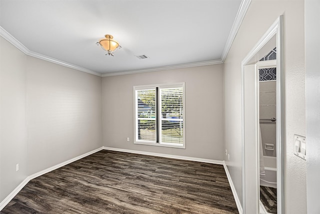 unfurnished room with visible vents, dark wood-type flooring, baseboards, and ornamental molding