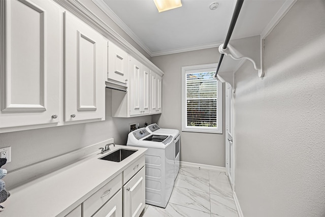 laundry area with washer and clothes dryer, ornamental molding, cabinet space, marble finish floor, and a sink