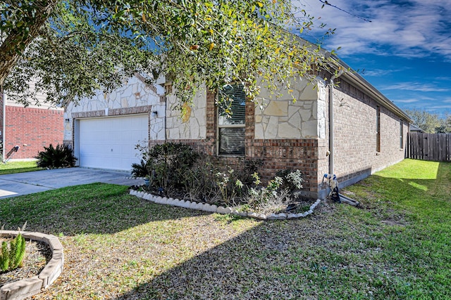 view of side of home featuring a lawn, fence, concrete driveway, an attached garage, and brick siding