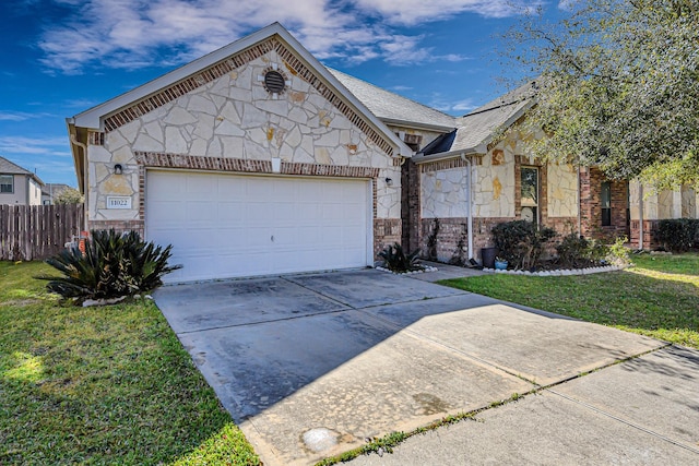 view of front of property with fence, driveway, an attached garage, a front lawn, and stone siding