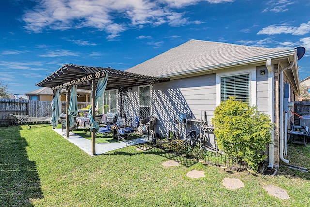 back of property with roof with shingles, a lawn, a fenced backyard, a patio area, and a pergola