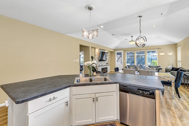 kitchen with dishwasher, open floor plan, a chandelier, and a sink