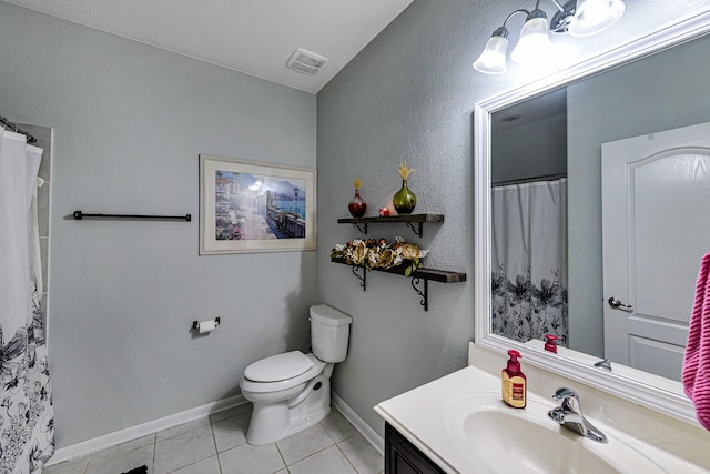 bathroom featuring visible vents, toilet, tile patterned flooring, baseboards, and vanity