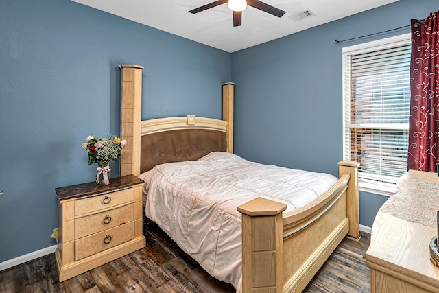 bedroom with visible vents, baseboards, dark wood-type flooring, and ceiling fan