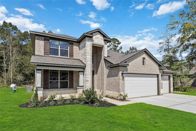 view of front of home featuring brick siding, an attached garage, central AC, a front yard, and driveway