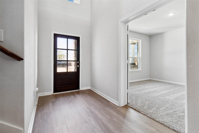 entryway with baseboards and wood finished floors