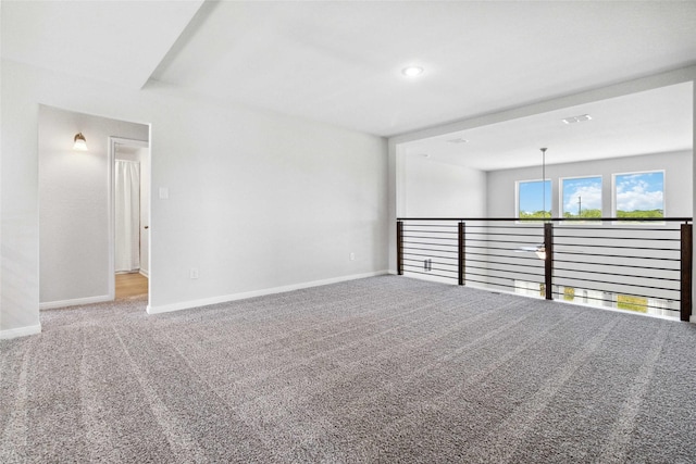 carpeted spare room featuring recessed lighting, visible vents, and baseboards