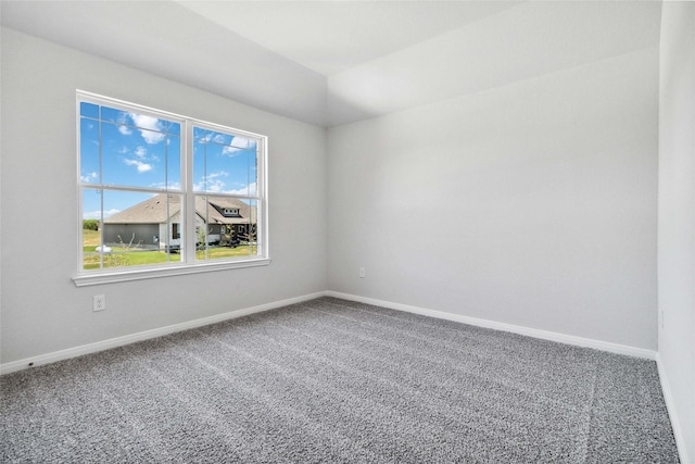 carpeted spare room with baseboards