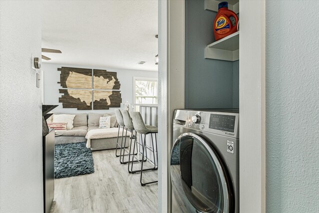 16715 Montego Way, Jamaica Beach, TX 77554 - laundry room with laundry area, wood finished floors, a textured wall, washer / dryer, and ceiling fan