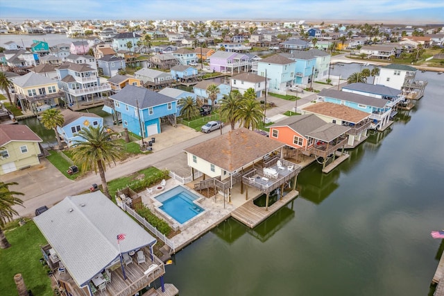 drone / aerial view with a residential view and a water view