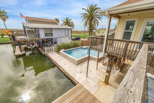 outdoor pool with a deck with water view