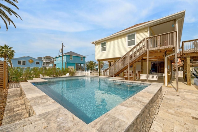 view of pool with a patio area, stairway, a deck, and fence