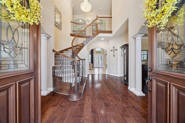 23421 Cannondale Loop, Montgomery, TX 77316 - foyer with baseboards, a high ceiling, dark wood-type flooring, stairway, and ornate columns